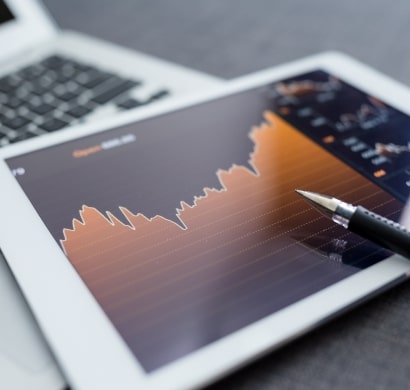 Whissel Strategies A tablet displaying a line graph with an upward trend is placed next to a laptop keyboard, with a pen resting on the screen—reflecting the data-driven approach of Whissel Strategies, a leading Toronto Marketing Agency. Toronto Digital Marketing Agency