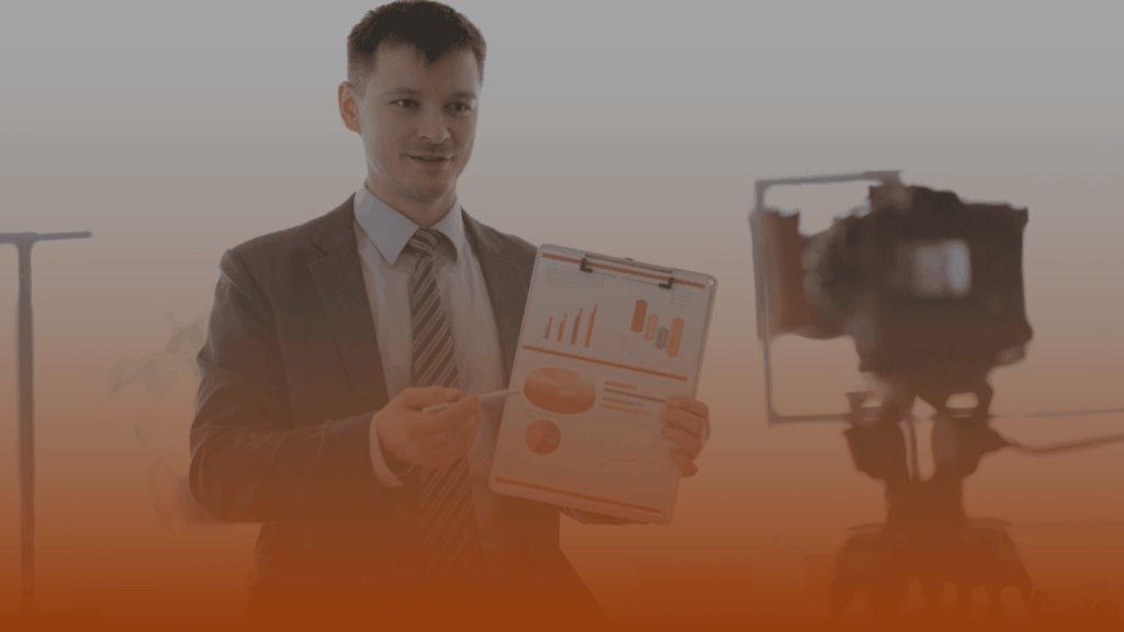 Whissel Strategies Man in a suit presenting charts on a clipboard while standing in front of a camera in an indoor setting. Toronto Digital Marketing Agency