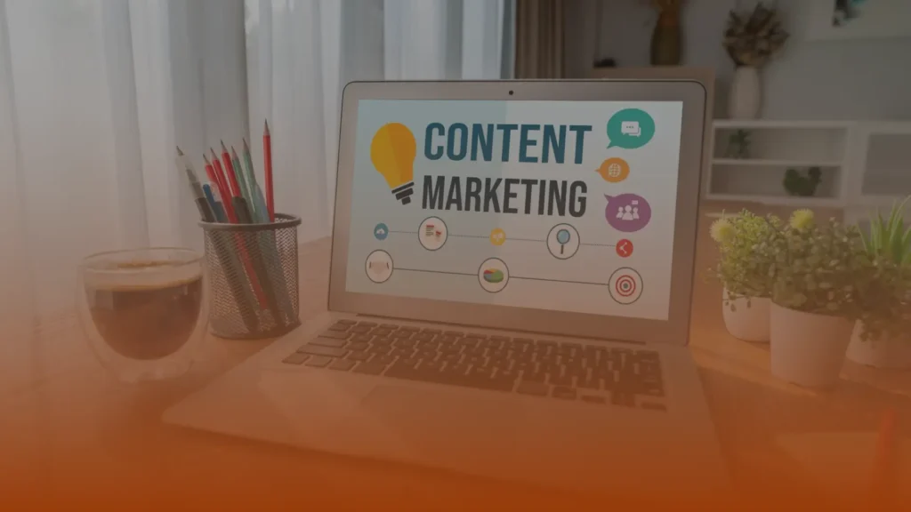 Whissel Strategies A laptop on a desk displays a “Content Marketing” graphic, surrounded by icons; nearby are a cup of coffee, pencils in a holder, and potted plants. Toronto Digital Marketing Agency