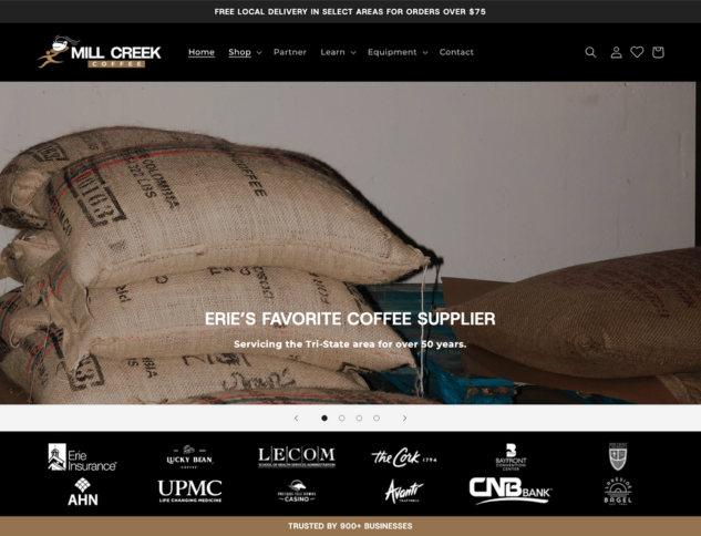 Whissel Strategies Bags of coffee beans stacked on top of each other in front of a wall, featured on the home page of Mill Creek Coffee Company's website. Toronto Digital Marketing Agency