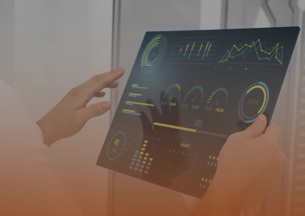 Whissel Strategies Person holding a transparent digital tablet displaying various data visualizations, including bar charts, graphs, and circular diagrams. Toronto Digital Marketing Agency